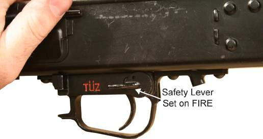 Install the safety lever into the left side of the receiver and set the safety lever on FIRE. Refer to Figure 23. Figure 23. Installing the Safety Lever and the Safety Lever on FIRE. 8.