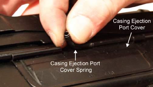 TM 8370-50107-IN/18 0012 00 12. Insert the spring bushings into the ends of the casing ejection port cover spring. Refer to Figure 28. Figure 28. Spring Bushings and Casing Ejection Port Cover Spring.