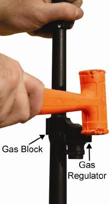 Remove the gas regulator from the gas block by holding the barrel in a vertical