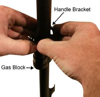 TM 8370-50107-IN/18 0013 00 11. Spread and slide the handle bracket past the gas block and remove it from the barrel. Refer to Figure 11. Figure 11. Removing the Handle Bracket.