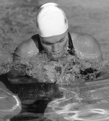 Penny Heyns, a former U n i v e r s i t y o f N e b r a s k a standout, earned two gold medals and became the first female in Olympic history to sweep the breaststroke events.