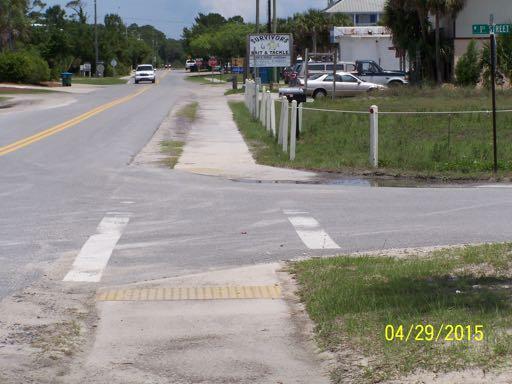 Transportation. The sidewalk is 5 feet wide. There are detectable warning surfaces (truncated domes) across the sidewalk at every street intersection.