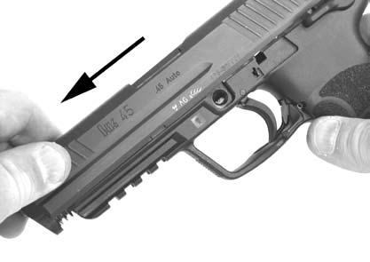 With the non-firing hand, completely remove the slide release from the left side of the frame by pressing on it from the right side of the frame (Figure 12), and