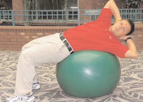 C RUSSIAN TWIST (C) While lying on your swiss ball, rotate your