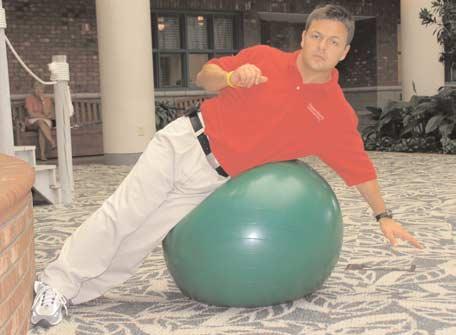 SIDE CRUNCH (D) Lie on your side with the swiss ball at your waist.