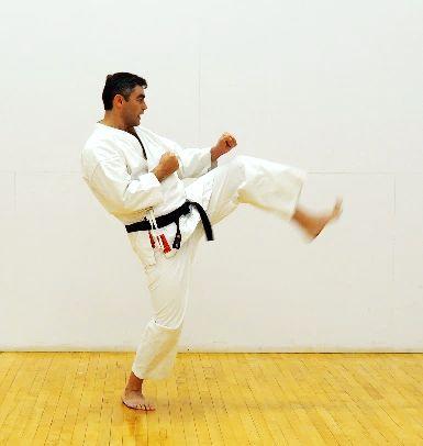 with placing back foot on the ground and starting the kick (b).