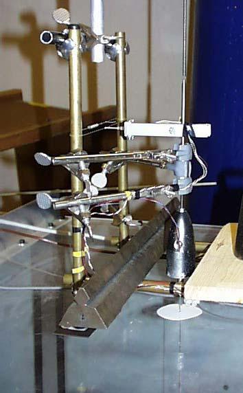 Figure 3-9 Torque measurement system with motor in torpedo like housing, bearings on spring loaded mounting rod in grey housing and spring balanced strain gauge bridge attached to the mounting rod to