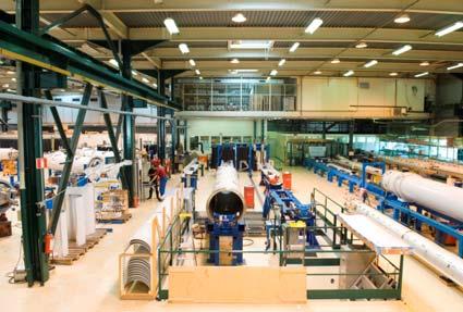 2 FIGURE 1. Pictures of the assembly halls of the LHC Short Straight Sections (left), dipole cryostats (right) at CERN.