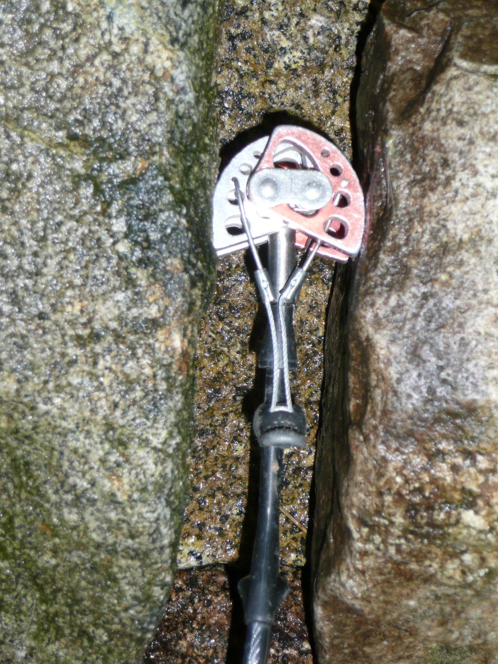 It should not loosen or even come out when wiggling the wire. A well placed cam should contact the rock at low to mid expansion range: 50% to 90% retracted.