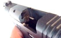 Next, point the muzzle in a safe direction, depress the magazine release and remove the magazine. (Figure 5.) Figure 5 2.