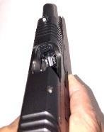 Next, draw the slide fully rearward in order to extract any cartridge from the chamber. DO NOT obstruct the ejection port because doing so can interfere with ejection of a cartridge. Figure 6 3.