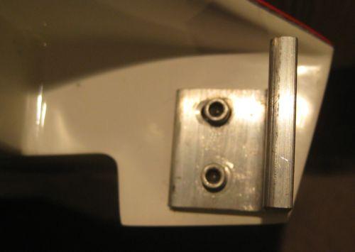 After both holes are drilled and both blind nuts are installed, remove the bracket and slot the upper hole. The upper slot will enable the bracket to rotate about the bottom pivot point.