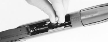 Then, insert the next cartridge in the same manner, pushing the preceding cartridge base down onto the previous cartridge just forward of the magazine feed guides, then down into the magazine as