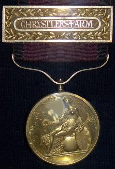 DESCRIPTION A small (33-mm diameter), circular gold medal with Britannia seated on the obverse (similar to the first type of the Order of the British Empire).