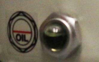 The Oil level sight glass for the compressor is located on the side of the pumps. Oil level should be ½ to 2/3 full.