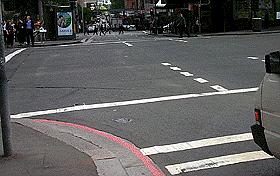 IN043 - Intersections You wish to turn left here. The pedestrian lights are flashing red.