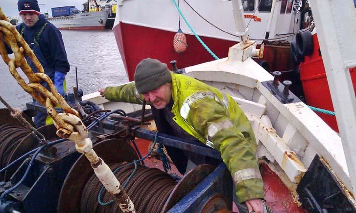 Crew member simulating working with starboard drum end, unable to reach winch operating