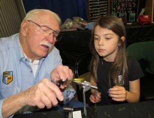 This show is a great opportunity for our club to share our tying and fishing knowledge with young and older folks and we encourage those not volunteering to come by, try a little tying yourself and
