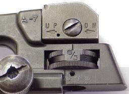 that the line on the rear sight aperture is aligned with the center line on the windage scale.