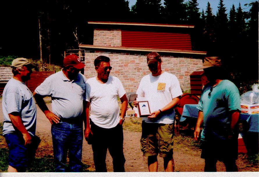 (right). John Kappler (right) awarding the second place plaque and prize money to the Miss Conduct Joe Rodney Markham (second right), Asiala (second left), Captain Jim Markham (middle).