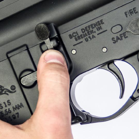 Lock the Bolt open by pulling the Charging Handle fully to the rear, then press the bottom of the Bolt Catch into the Lower Receiver while slowly allowing the