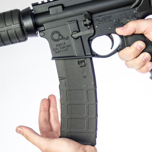 5. If the Bolt is closed, keep fingers away from the Ejection Port, pull the Charging Handle all the