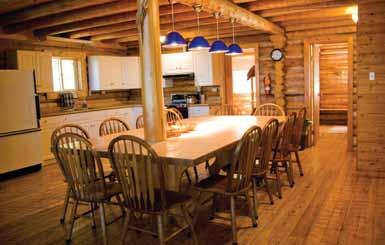 shore lunch area 2,400 sq ft, two-storey beautiful log construction Four bedrooms (12 beds total) Two separate washrooms and shower rooms Screened-in deck Open cathedral-ceiling living room with