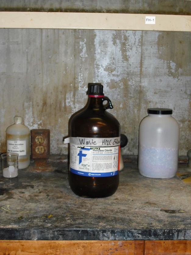 Every container must have the chemical constituents clearly written on the Hazardous Waste label; trade names, chemical symbols and chemical structures are unacceptable and subject to substantial