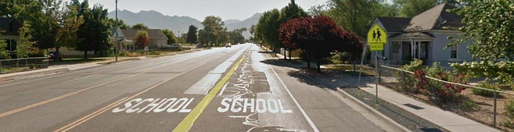 either side. It has advanced school crossing pavement markings and signs at approximately 400 feet to the east and west.