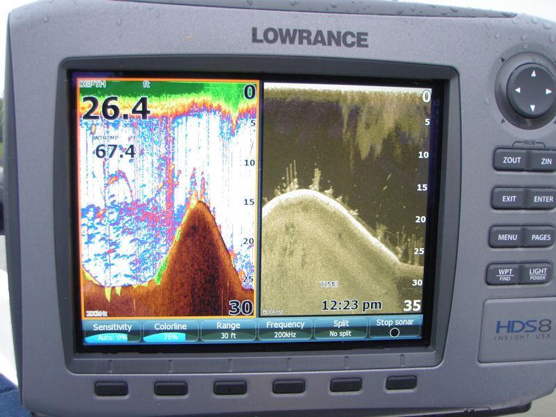 The screen shows bass, crappie and stripes located in and around submerged stake beds on an isolated mid-bay hump.