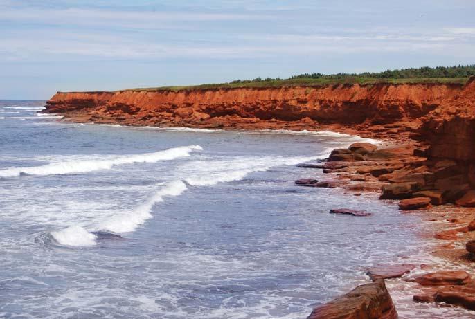 5. The shoreline of Prince Edward Island is made of red sandstone cliffs and sandy beaches. A tourist standing on a beach is 30 m from the base of a vertical cliff.