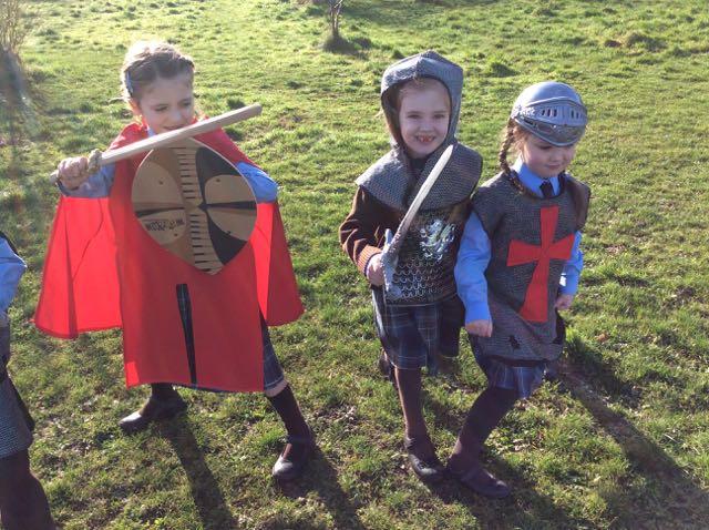 wearing various pieces of armour and carrying shields and swords.