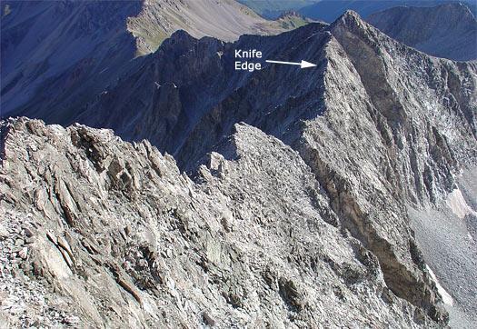 Scramble along the crest and find footholds along the side while holding onto the ridge. Experienced climbers can carefully walk across much of the Knife Edge.