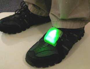 figure 1. The covered Omron HJ-112 pedometer that all participants would wear to log their step counts. figure 2. Pediluma strapped to a shoe and fully lit.