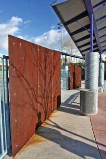 Corrugated and galvanized metals, and Corten steel, were two of the primary materials. The Corten steel panels are punched and sandwiched with red acrylic plastic.