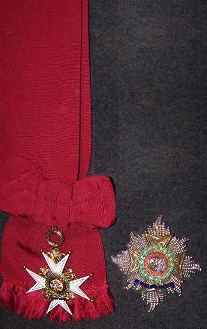 Military Civil DESCRIPTION Knight Grand Cross (GCB) The Knight Grand Cross wears a large badge (89-mm wide) from a 102-mm wide crimson ribbon, which passes over the right shoulder and displays the
