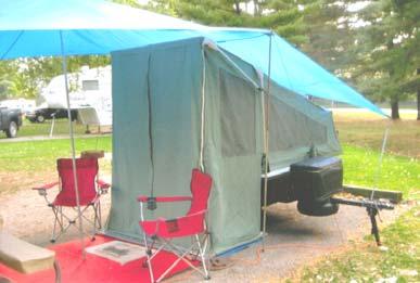 KWIK CAMP CAMPER Like New, always stored inside Queen Bed 2 Canopies Add a room Light Bar Bumper 2 covers (one is larger for more storage) Call for information (517) 451-8435 Last Chance to register