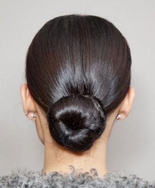 You can usually get rid of stray hairs by using a bristle brush to smooth them back once you have made your ponytail. The height of your ponytail should be in line with the type of bun you want.
