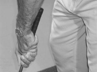 Take your normal grip but choke down so your back hand is slightly on the metal of the club
