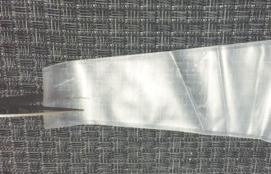 4. Remove one (1) disposable drape and two (2) security bands from the