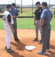 base umpire will position himself / herself by facing the plate umpire on the fair side of home plate.