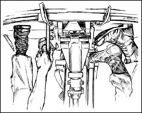 Figure 6-23. Assistant gunner locking the turntable traversing handle.