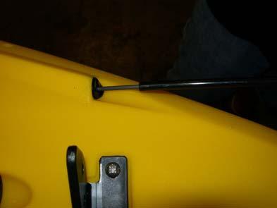 Spray the tubing with soapy water (or another lubricant) and insert it into one of the stern grommets. See photo D.