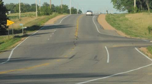 I.3) Provide Bypass Lanes at T-Intersections (T) A bypass lane can be used at a 2-lane rural or urban T-intersection. Provide an auxiliary lane to create an abbreviated left-turn lane.