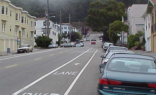 intersections. Uphill Bike Lanes and Downhill Sharrows to separate people on bikes going uphill- and to indicate shared lane for cyclists traveling downhill.