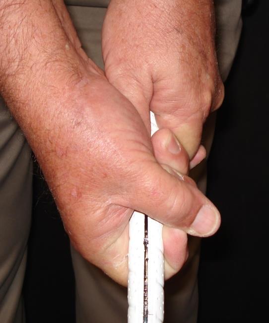 The trigger finger middle knuckle will rest slightly on the right side of the golf club.