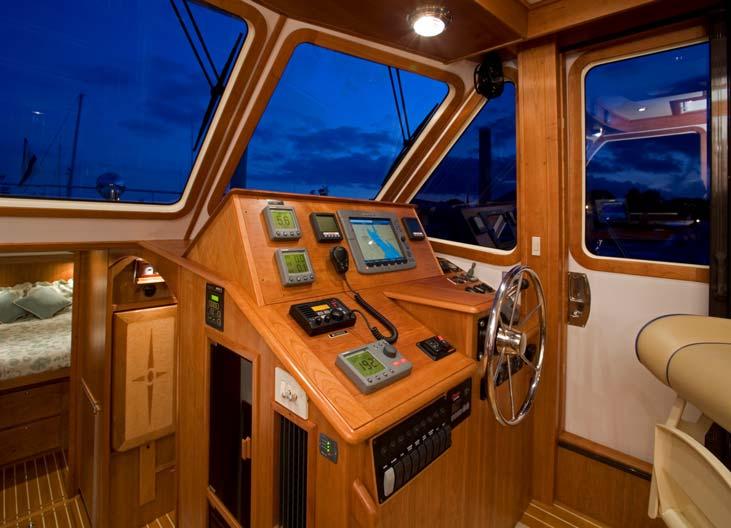 The instruments at the helm include a RayMarine E120 plotter, autopilot, repeaters, and engine displays.