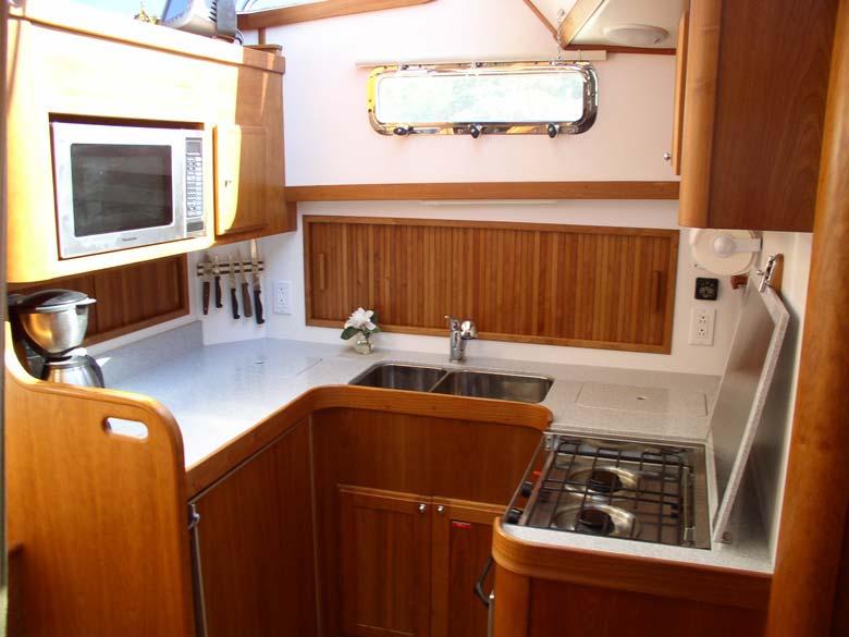 The "U" shaped galley includes a propane stove with oven.