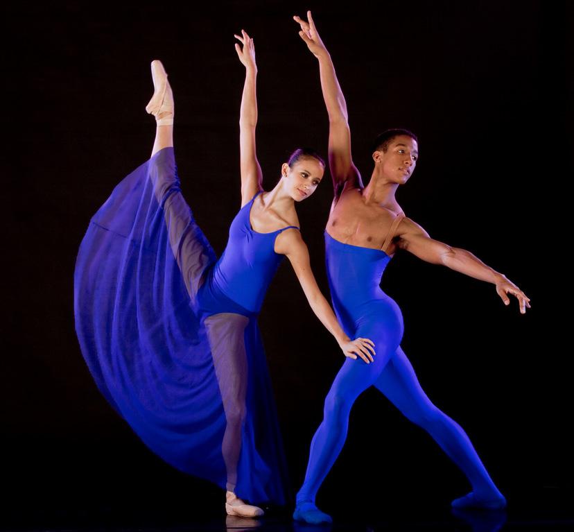 In the top left photo, the female dancer is wearing a classical tutu, pointe shoes and tiara.