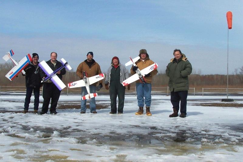 The pilots pose with some of their planes at the Winter Fun Fly.